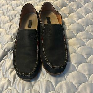 Black & tan pair of OluKai shoes